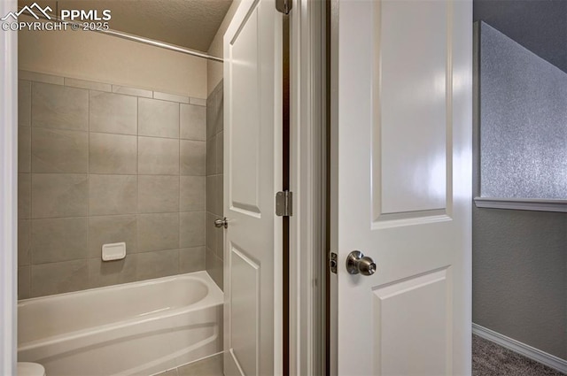 8235 Kittrick Pl, Falcon, CO 80831 - bathroom featuring shower / bathtub combination and baseboards