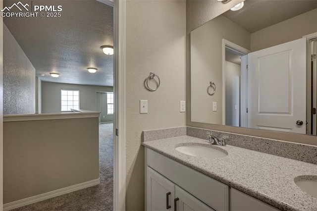 8235 Kittrick Pl, Falcon, CO 80831 - bathroom with double vanity and a textured wall