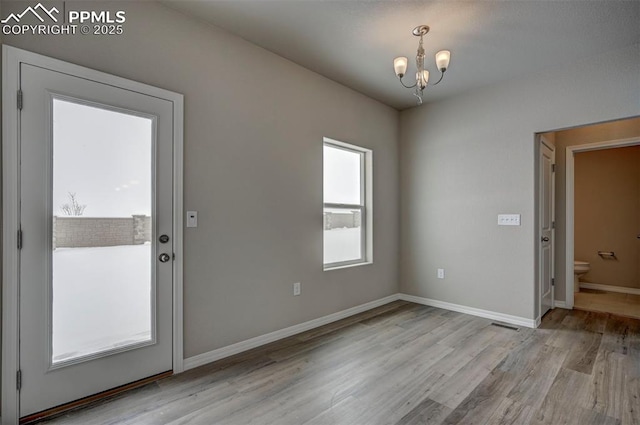 8235 Kittrick Pl, Falcon, CO 80831 - doorway to outside featuring a chandelier and wood finished floors