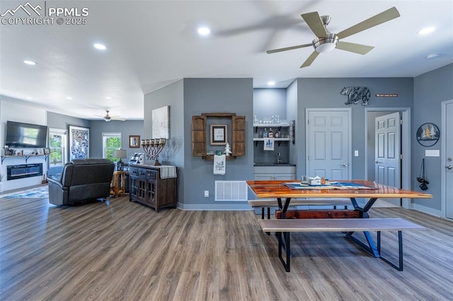 333 Della Fox Ln, Westcliffe, CO 81252 - dining area featuring wood finished floors, ceiling fan, recessed lighting, and a glass covered fireplace