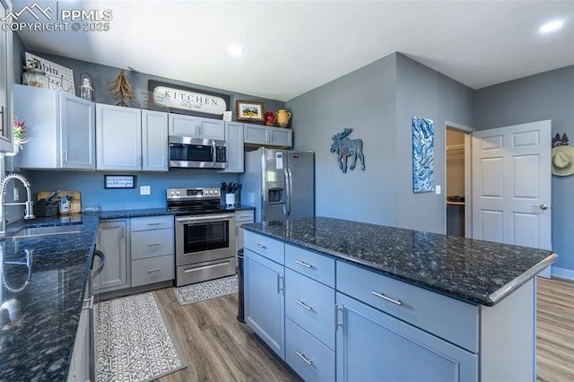 333 Della Fox Ln, Westcliffe, CO 81252 - kitchen with appliances with stainless steel finishes, wood finished floors, a center island, dark stone counters, and recessed lighting