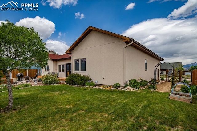 106 Red Tail Blvd, Buena Vista, CO 81211 - rear view of property featuring a garden, stucco siding, and a patio area