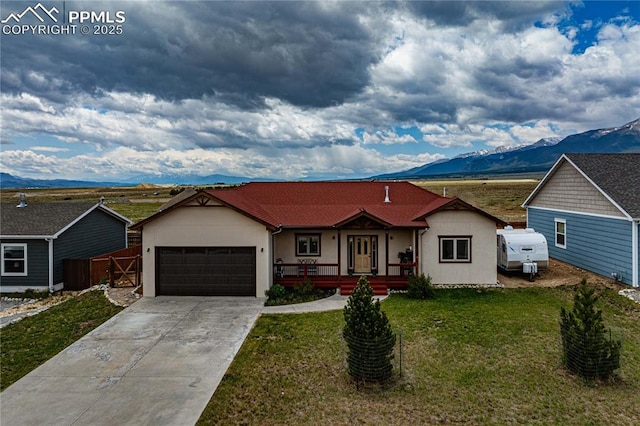 106 Red Tail Blvd, Buena Vista, CO 81211 - view of front facade with a mountain view, an attached garage, a porch, driveway, and stucco siding