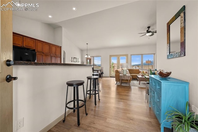106 Red Tail Blvd, Buena Vista, CO 81211 - kitchen with light wood-style flooring, ceiling fan, a breakfast bar, lofted ceiling, and dark countertops