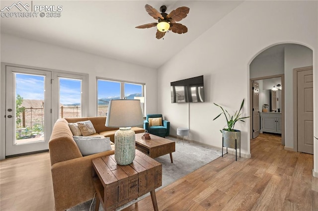 106 Red Tail Blvd, Buena Vista, CO 81211 - living area featuring arched walkways, high vaulted ceiling, a ceiling fan, and light wood-style flooring