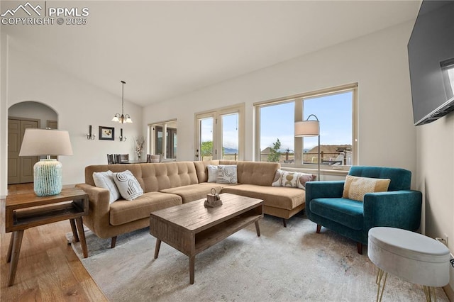 106 Red Tail Blvd, Buena Vista, CO 81211 - living room featuring a chandelier, light wood-type flooring, vaulted ceiling, and arched walkways