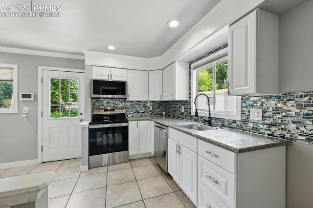 1137 Pando Ave, Colorado Springs, CO 80905 - kitchen with stainless steel appliances, healthy amount of natural light, decorative backsplash, white cabinets, and recessed lighting
