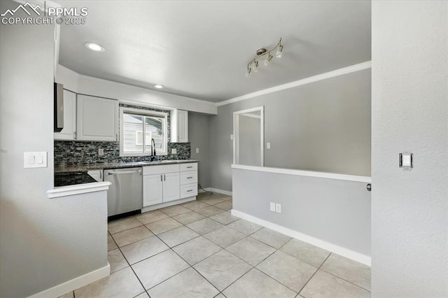 1137 Pando Ave, Colorado Springs, CO 80905 - kitchen featuring stainless steel dishwasher, white cabinetry, light tile patterned floors, backsplash, and dark countertops