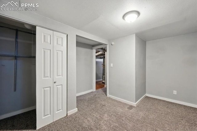 1137 Pando Ave, Colorado Springs, CO 80905 - unfurnished bedroom featuring a closet, carpet flooring, and a textured ceiling