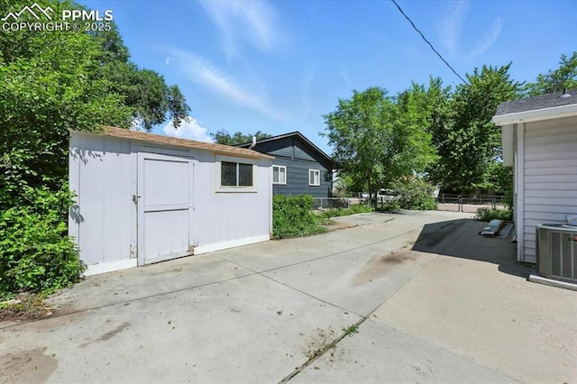 1137 Pando Ave, Colorado Springs, CO 80905 - view of side of home featuring a storage unit and a patio area