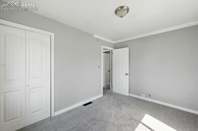 1137 Pando Ave, Colorado Springs, CO 80905 - unfurnished bedroom featuring carpet floors, a closet, and crown molding