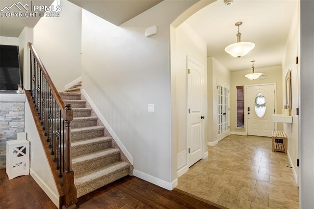 10280 Abrams Dr, Colorado Springs, CO 80925 - foyer with arched walkways and stairway