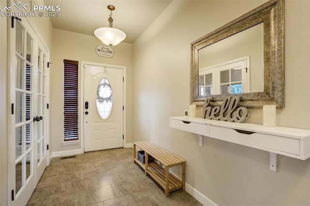 10280 Abrams Dr, Colorado Springs, CO 80925 - entryway featuring french doors and baseboards