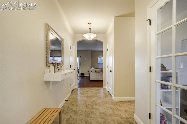 10280 Abrams Dr, Colorado Springs, CO 80925 - hall featuring arched walkways and baseboards