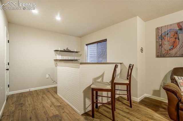 10280 Abrams Dr, Colorado Springs, CO 80925 - bar area featuring wood finished floors and baseboards