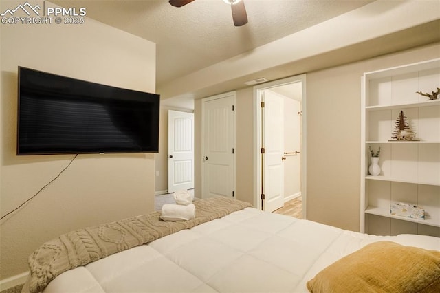 10280 Abrams Dr, Colorado Springs, CO 80925 - bedroom featuring ensuite bath, a ceiling fan, and a textured ceiling