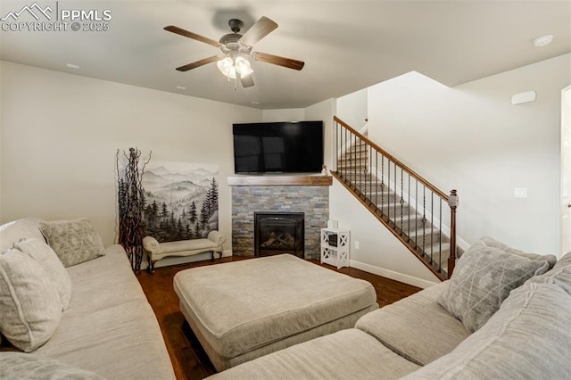 10280 Abrams Dr, Colorado Springs, CO 80925 - living area featuring a ceiling fan, a fireplace, stairs, and dark wood finished floors