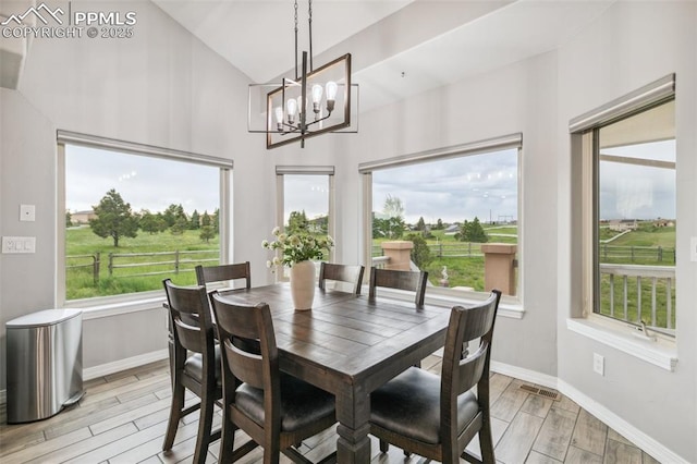 7416 Crow Ct, Colorado Springs, CO 80908 - dining room with light wood-type flooring, a chandelier, high vaulted ceiling, and plenty of natural light