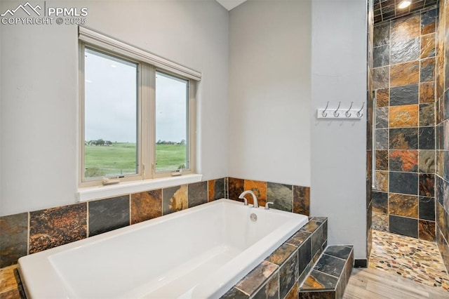 7416 Crow Ct, Colorado Springs, CO 80908 - bathroom featuring a garden tub, tiled shower, and wood finished floors