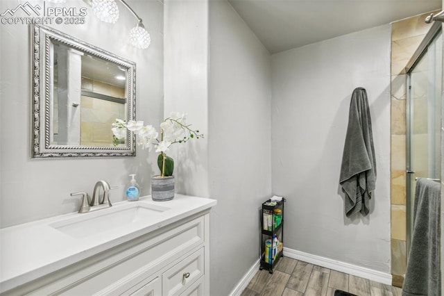 7416 Crow Ct, Colorado Springs, CO 80908 - full bathroom featuring vanity, wood finished floors, and a tile shower