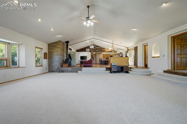 2550 Slocum Rd, Peyton, CO 80831 - carpeted living room featuring a wood stove, vaulted ceiling, and ceiling fan