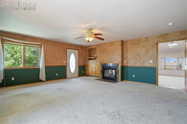 2550 Slocum Rd, Peyton, CO 80831 - unfurnished living room featuring ceiling fan, a premium fireplace, and light colored carpet