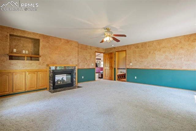 2550 Slocum Rd, Peyton, CO 80831 - unfurnished living room featuring a ceiling fan, a fireplace, and carpet
