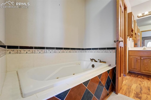 2550 Slocum Rd, Peyton, CO 80831 - full bath with a tub with jets, vanity, and wood finished floors
