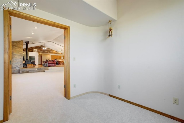 2550 Slocum Rd, Peyton, CO 80831 - carpeted spare room featuring a wood stove and lofted ceiling