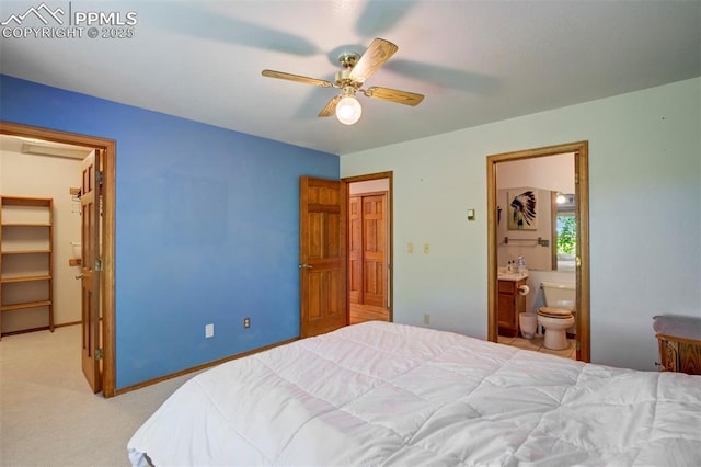 2550 Slocum Rd, Peyton, CO 80831 - carpeted bedroom with a walk in closet, ensuite bath, and a ceiling fan