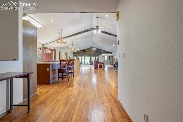 2550 Slocum Rd, Peyton, CO 80831 - living room with lofted ceiling, wood finished floors, ceiling fan, a chandelier, and a textured wall