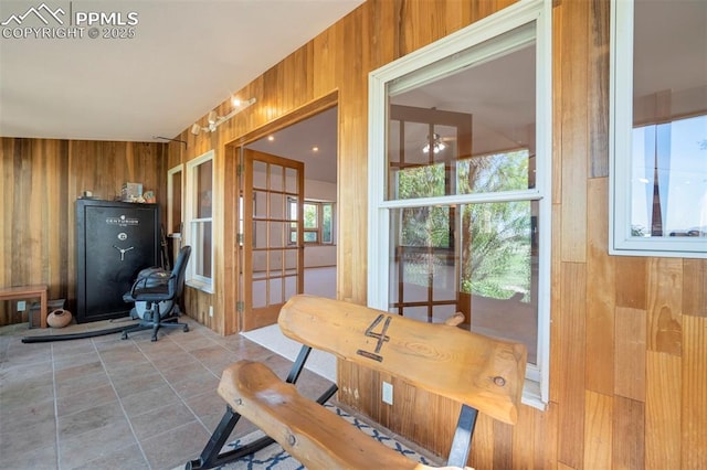 2550 Slocum Rd, Peyton, CO 80831 - dining space with wooden walls, tile patterned flooring, and a ceiling fan