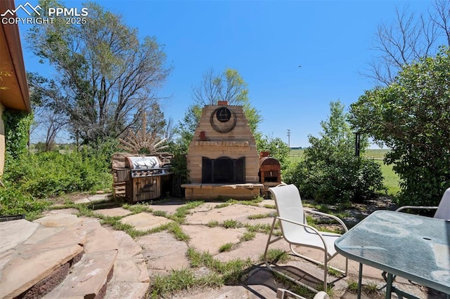 2550 Slocum Rd, Peyton, CO 80831 - view of patio / terrace with exterior fireplace
