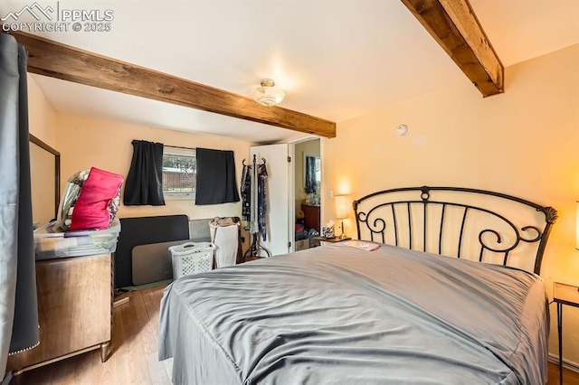 376 Gardenia Rd, Woodland Park, CO 80863 - bedroom featuring beamed ceiling and wood finished floors