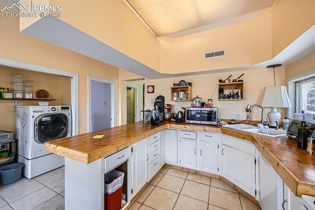 376 Gardenia Rd, Woodland Park, CO 80863 - kitchen with stainless steel microwave, light tile patterned floors, and butcher block countertops