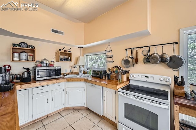 376 Gardenia Rd, Woodland Park, CO 80863 - kitchen featuring white appliances, white cabinetry, plenty of natural light, and light tile patterned flooring