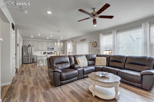 8101 Goldenray Pl, Colorado Springs, CO 80908 - living room with ceiling fan, recessed lighting, light wood-style floors, and a chandelier
