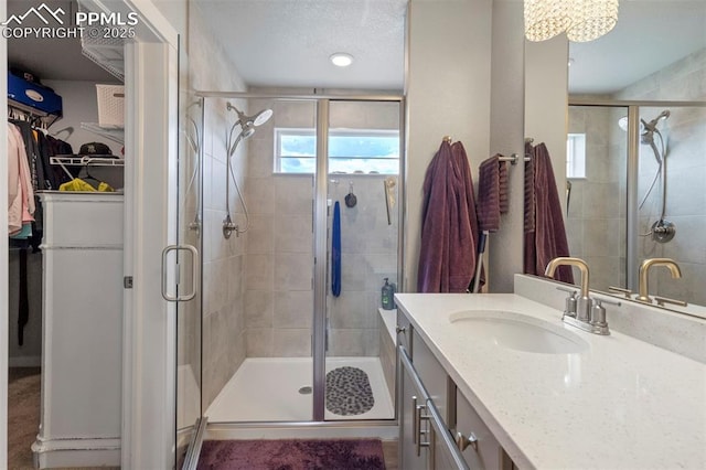 8101 Goldenray Pl, Colorado Springs, CO 80908 - bathroom featuring vanity, a stall shower, and a spacious closet