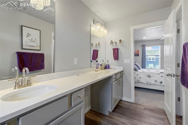 8101 Goldenray Pl, Colorado Springs, CO 80908 - full bath featuring connected bathroom, wood finished floors, and double vanity