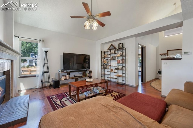 9503 Brisk Breeze Ct, Colorado Springs, CO 80925 - living area featuring a ceiling fan, wood finished floors, and a brick fireplace