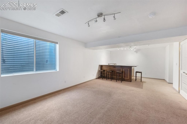 9503 Brisk Breeze Ct, Colorado Springs, CO 80925 - unfurnished room with rail lighting, bar, and carpet floors