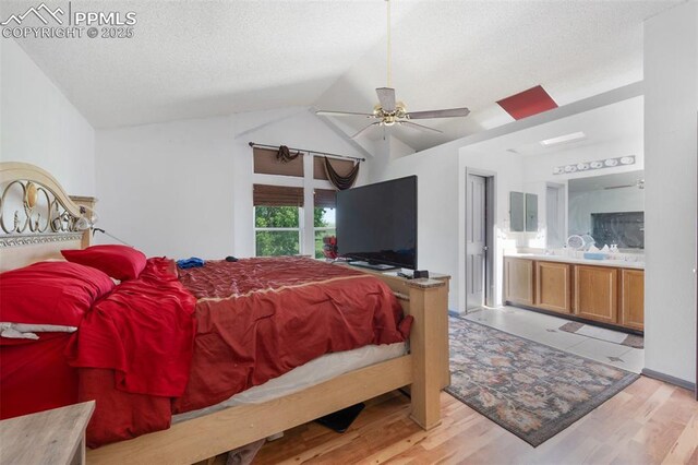 9503 Brisk Breeze Ct, Colorado Springs, CO 80925 - bedroom with vaulted ceiling, a textured ceiling, wood finished floors, and ensuite bathroom