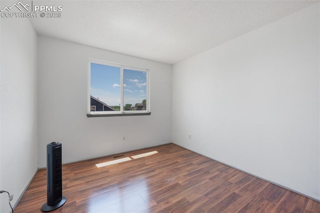 9503 Brisk Breeze Ct, Colorado Springs, CO 80925 - spare room with wood finished floors and a textured ceiling
