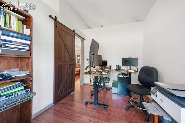 9503 Brisk Breeze Ct, Colorado Springs, CO 80925 - home office with a barn door, lofted ceiling, and dark wood-style flooring