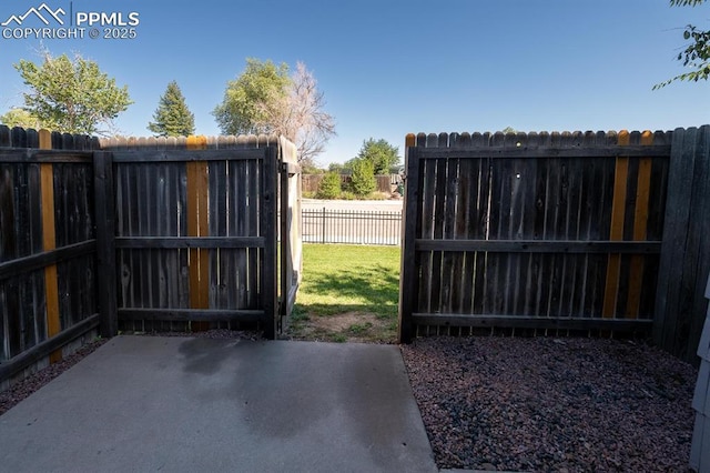 1363 Soaring Eagle Dr, Colorado Springs, CO 80915 - gate featuring a patio area and a fenced backyard
