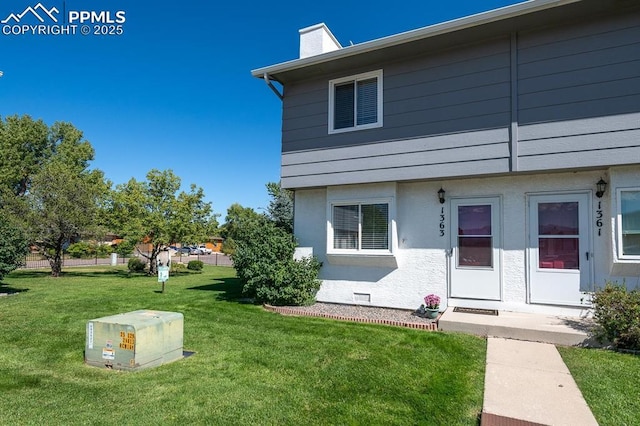 1363 Soaring Eagle Dr, Colorado Springs, CO 80915 - view of front of home with a front lawn and a chimney
