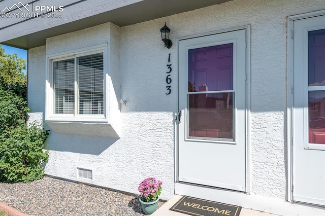 1363 Soaring Eagle Dr, Colorado Springs, CO 80915 - view of exterior entry with stucco siding