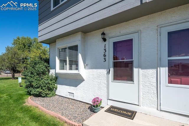1363 Soaring Eagle Dr, Colorado Springs, CO 80915 - doorway to property featuring stucco siding and a yard