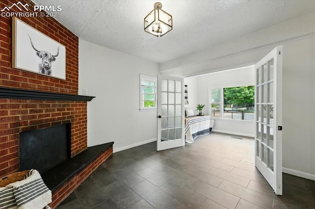 1314 Pioneer Rd, Colorado Springs, CO 80907 - living area featuring french doors, a textured ceiling, and a brick fireplace