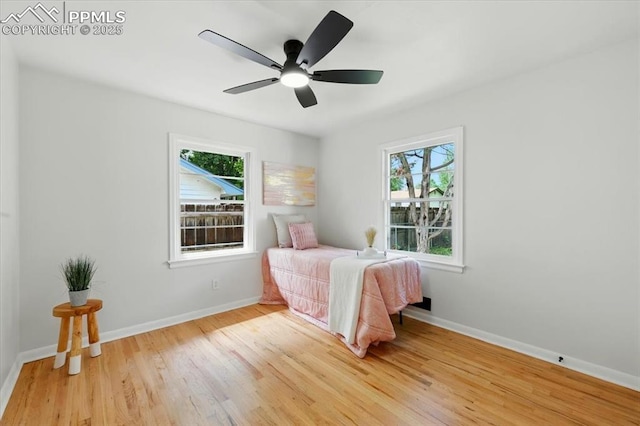 1314 Pioneer Rd, Colorado Springs, CO 80907 - bedroom featuring multiple windows, light wood finished floors, and ceiling fan